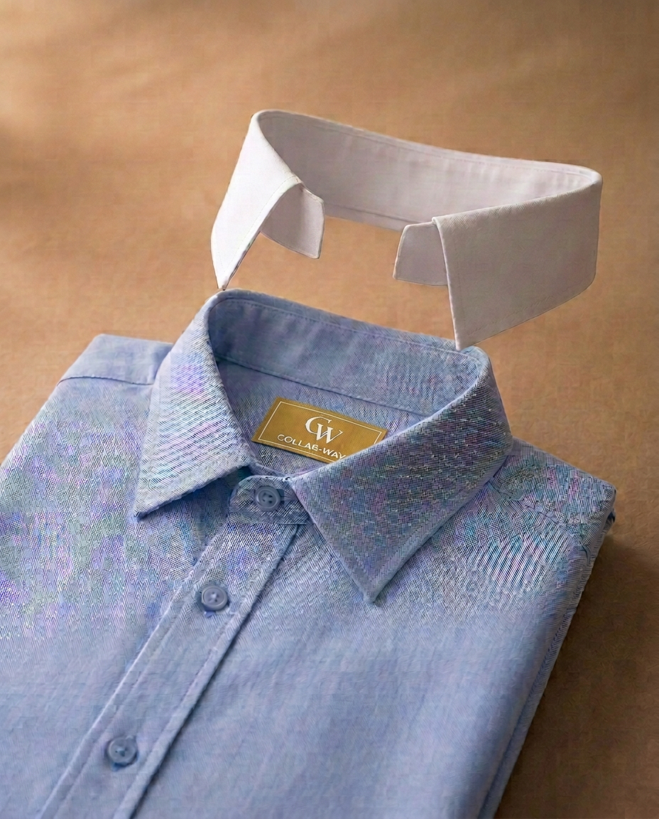A woven blue dress shirt with a matching blue collar attached and a detachable white Collar-Ways collar floating above the neckline